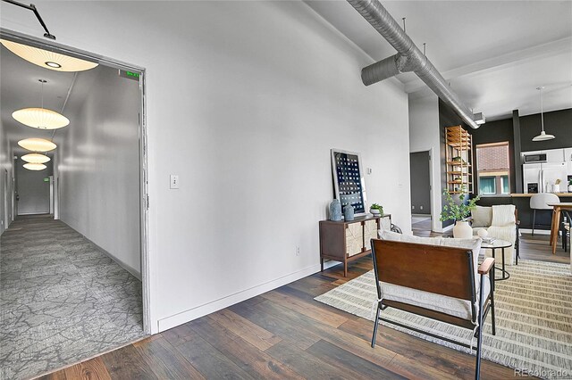 2501 15th St Unit 3F, Denver, CO 80211 - interior space with wood finished floors, beam ceiling, baseboards, and a towering ceiling