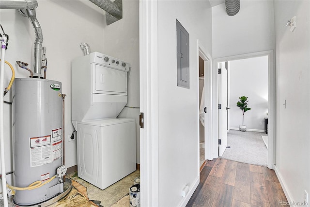 2501 15th St Unit 3F, Denver, CO 80211 - laundry room with estacked washer and dryer, gas water heater, wood finished floors, electric panel, and baseboards