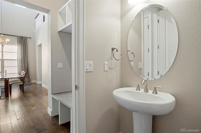 bathroom featuring sink, hardwood / wood-style floors, and a chandelier