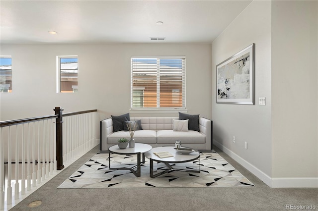 sitting room featuring light carpet