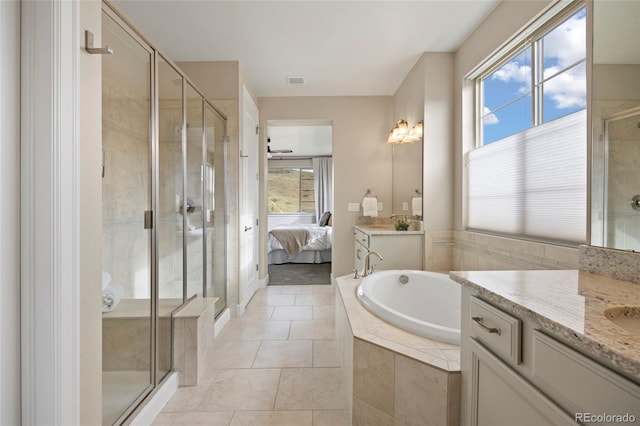 ensuite bathroom with a stall shower, plenty of natural light, vanity, and a bath