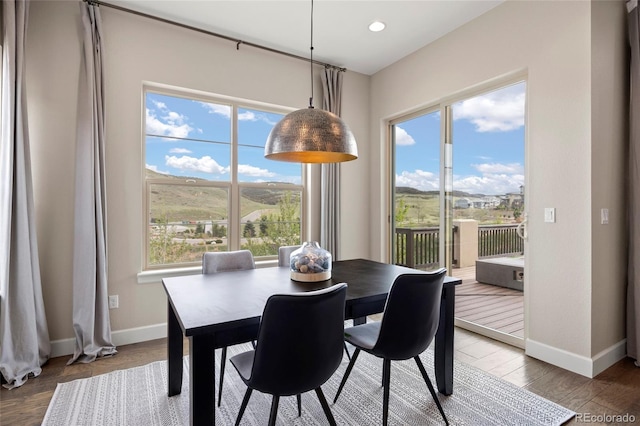dining space with baseboards, plenty of natural light, and recessed lighting
