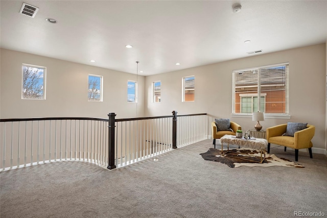 living area with carpet and recessed lighting