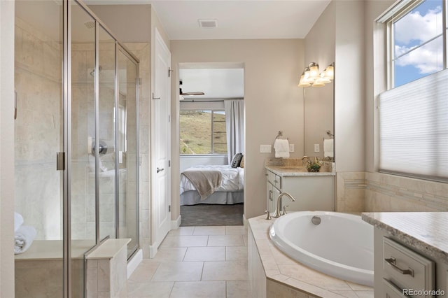 bathroom with vanity, a bath, a shower stall, and ensuite bathroom