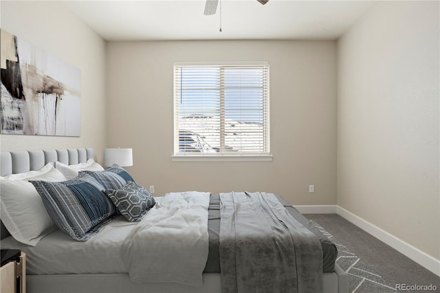 carpeted bedroom featuring baseboards and ceiling fan