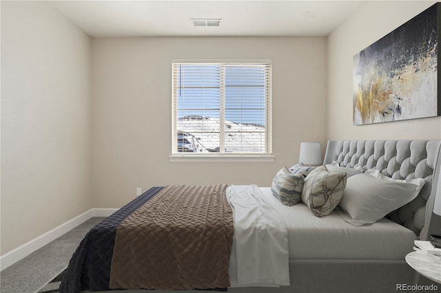 carpeted bedroom featuring baseboards