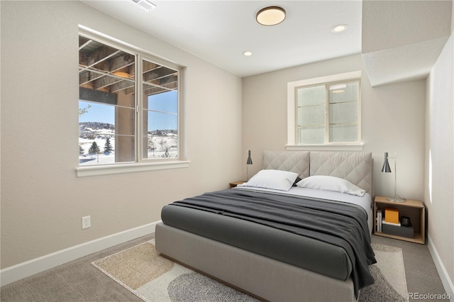 carpeted bedroom featuring baseboards and recessed lighting