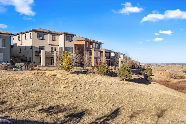back of property with stucco siding and a residential view