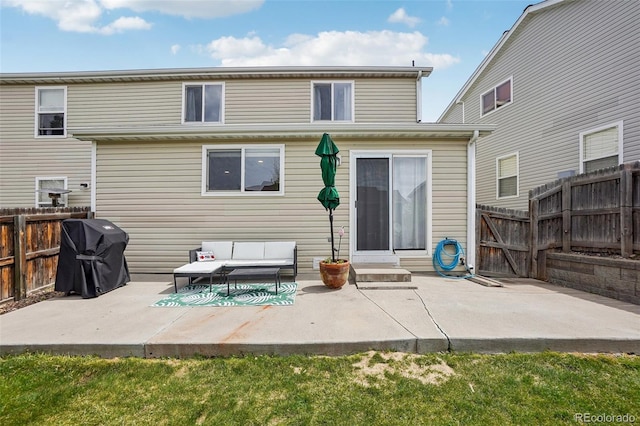 rear view of property with a fenced backyard, entry steps, a patio, and outdoor lounge area