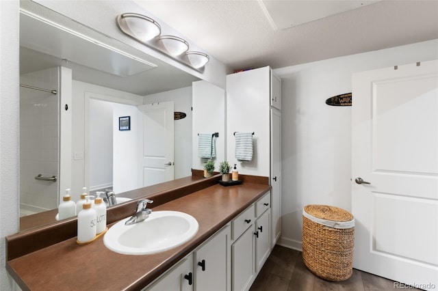 bathroom featuring vanity, hardwood / wood-style floors, and a textured ceiling