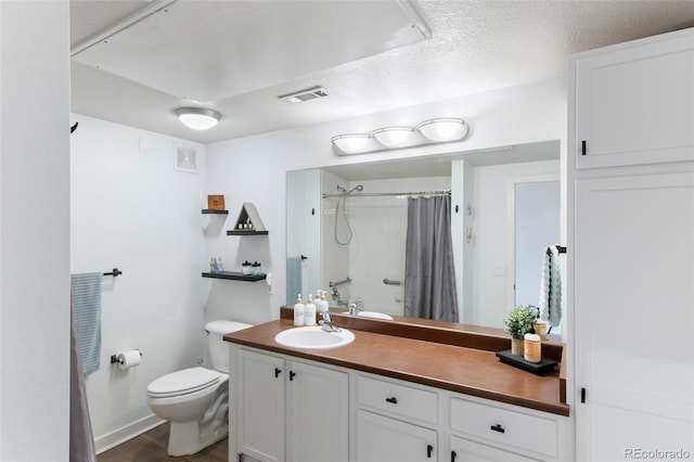 bathroom with toilet, a textured ceiling, vanity, curtained shower, and hardwood / wood-style floors