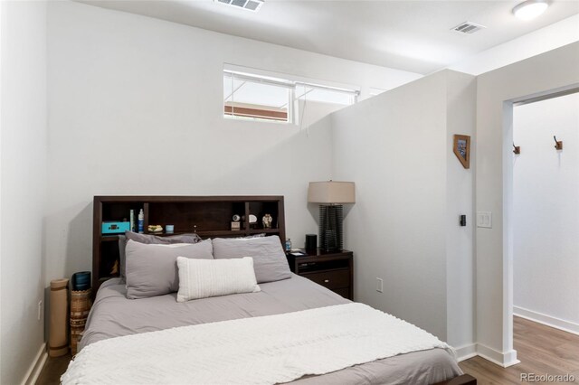bedroom with hardwood / wood-style floors
