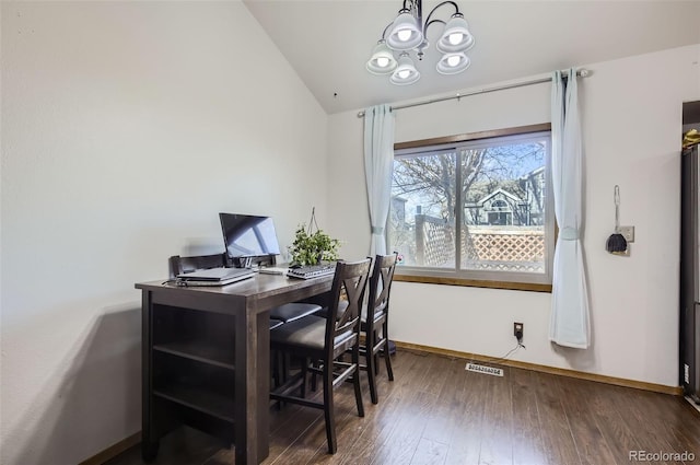 office featuring dark hardwood / wood-style flooring, a chandelier, and vaulted ceiling