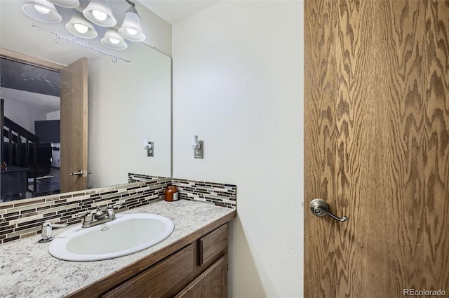 bathroom with decorative backsplash and vanity