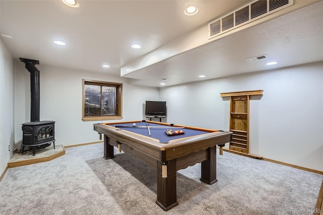 game room with carpet flooring, a wood stove, and billiards