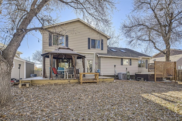 back of house with a gazebo, a hot tub, central AC unit, and a deck