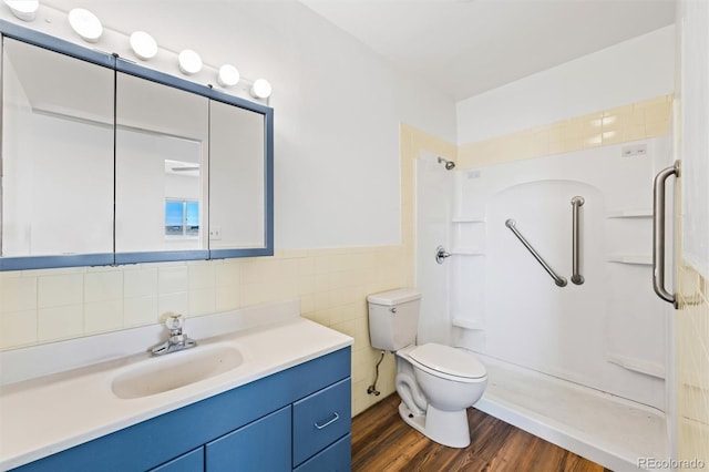 bathroom with tile walls, toilet, a shower, vanity, and hardwood / wood-style flooring