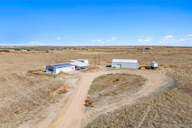 birds eye view of property with a rural view