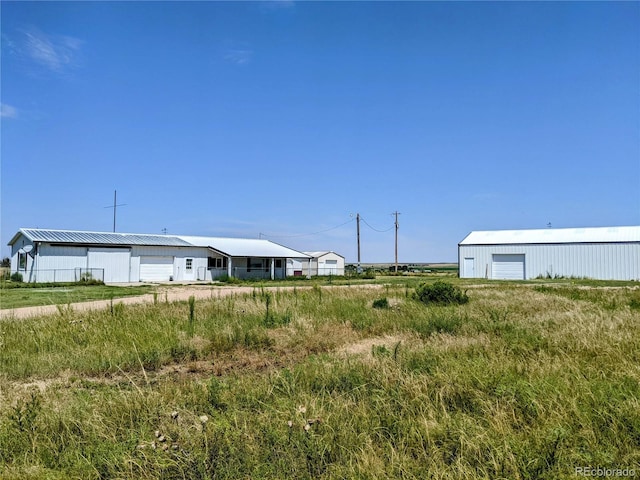 view of yard with a garage and an outdoor structure