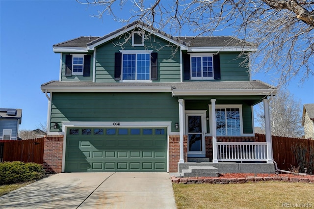 craftsman-style house featuring brick siding, covered porch, driveway, and fence