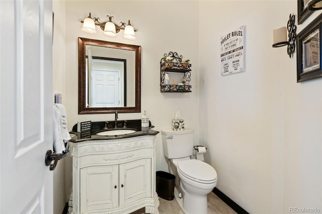 bathroom featuring toilet and vanity