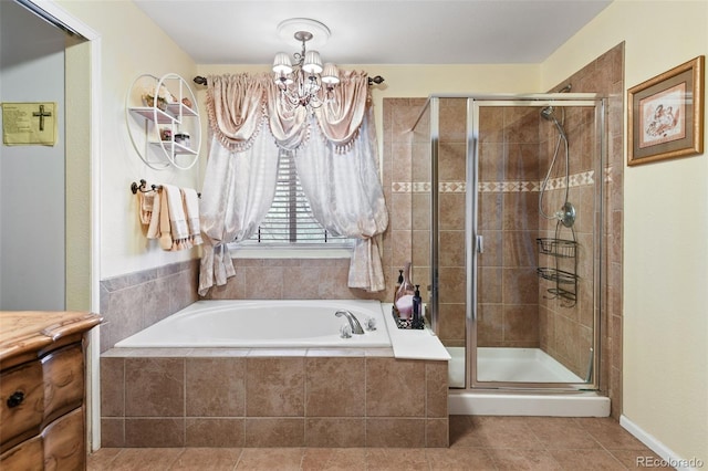 bathroom featuring a notable chandelier, a bath, a stall shower, and tile patterned flooring