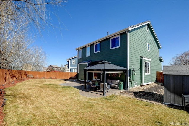 back of house featuring a gazebo, a fenced backyard, and a patio area