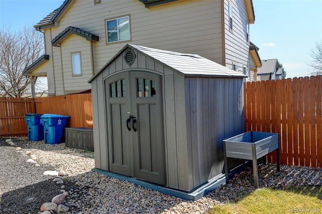 view of shed featuring a fenced backyard