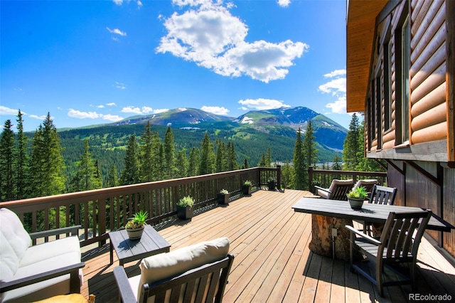 deck featuring a mountain view and an outdoor hangout area