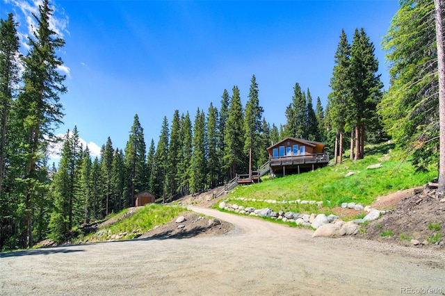 view of front of property with a storage shed