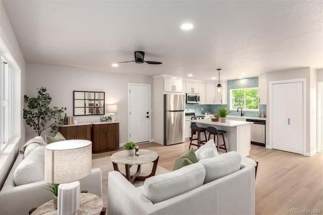 1011 Yeager Dr, Longmont, CO 80501 - living room featuring light wood-style flooring, ceiling fan, and recessed lighting
