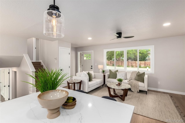 1011 Yeager Dr, Longmont, CO 80501 - living area with light wood-type flooring, a ceiling fan, stairs, and recessed lighting
