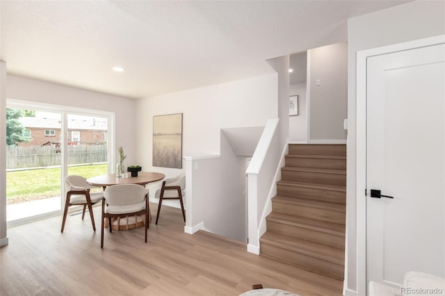 1011 Yeager Dr, Longmont, CO 80501 - dining area with light wood-style flooring, stairs, and recessed lighting