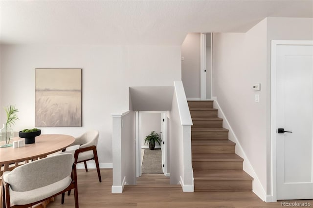 1011 Yeager Dr, Longmont, CO 80501 - stairs featuring wood finished floors and baseboards
