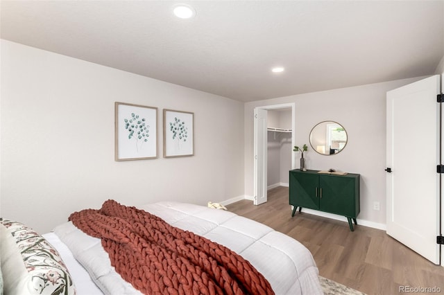 1011 Yeager Dr, Longmont, CO 80501 - bedroom featuring light wood-style floors, recessed lighting, a walk in closet, and a closet