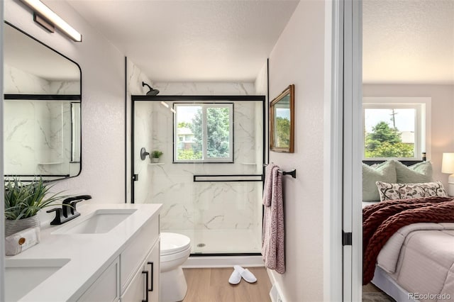 1011 Yeager Dr, Longmont, CO 80501 - full bathroom featuring ensuite bath, healthy amount of natural light, a marble finish shower, double vanity, and a textured ceiling