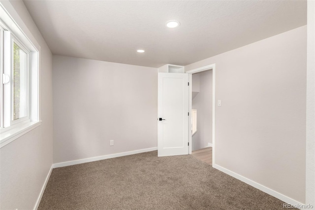 1011 Yeager Dr, Longmont, CO 80501 - empty room with light colored carpet and recessed lighting