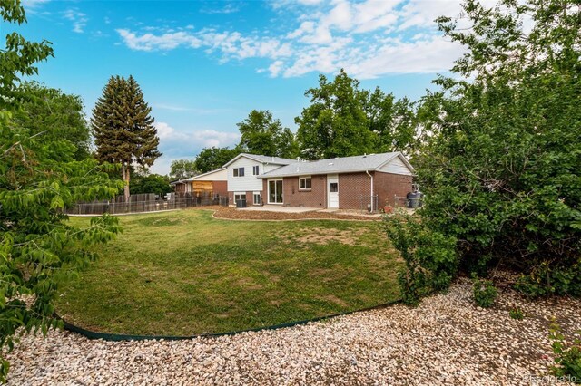 1011 Yeager Dr, Longmont, CO 80501 - back of house with brick siding and a patio