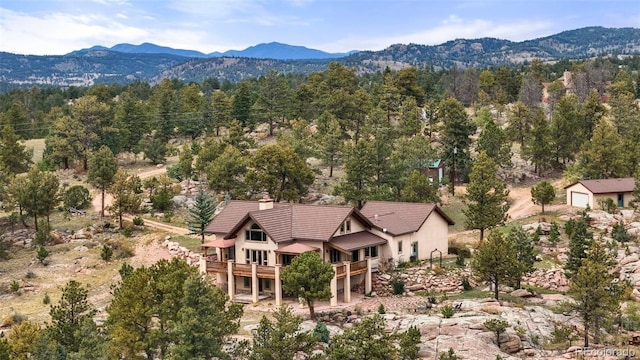 aerial view featuring a mountain view and a view of trees