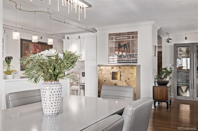 dining area featuring ornamental molding and dark hardwood / wood-style flooring