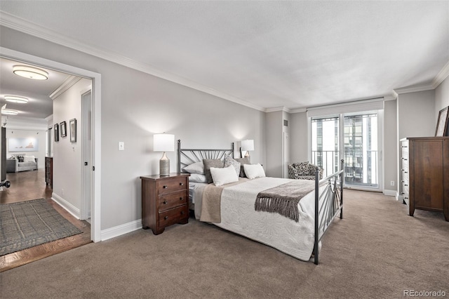 bedroom with ornamental molding and carpet flooring