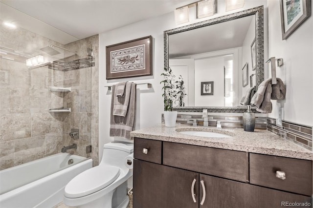 full bathroom with vanity, toilet, and tiled shower / bath