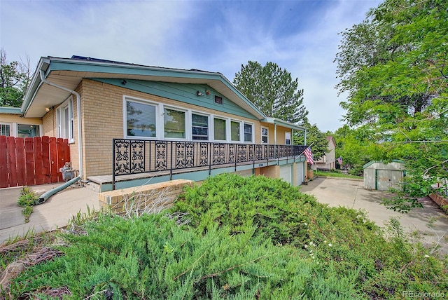 8300 W 67th Ave, Arvada, CO 80004 - view of front of property with brick siding and an attached garage