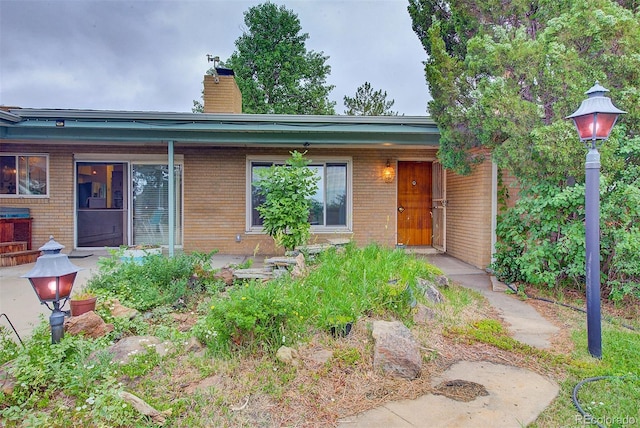 8300 W 67th Ave, Arvada, CO 80004 - back of house with brick siding and a chimney