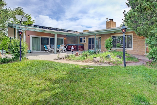 8300 W 67th Ave, Arvada, CO 80004 - back of house with a patio area, a lawn, brick siding, and a chimney