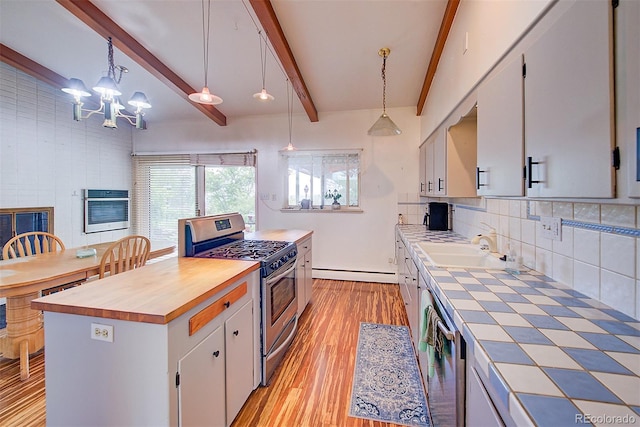 8300 W 67th Ave, Arvada, CO 80004 - kitchen featuring appliances with stainless steel finishes, light wood-style floors, a chandelier, backsplash, and white cabinetry