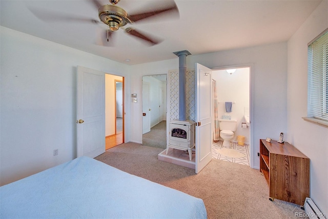 8300 W 67th Ave, Arvada, CO 80004 - carpeted bedroom with a wood stove, heating unit, a baseboard heating unit, ensuite bathroom, and ceiling fan