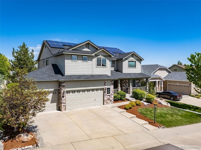 22227 E Hinsdale Ave, Aurora, CO 80016 - view of front of house featuring covered porch, driveway, solar panels, and a garage
