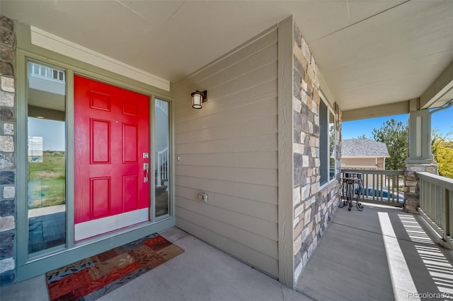 22227 E Hinsdale Ave, Aurora, CO 80016 - property entrance with covered porch and stone siding