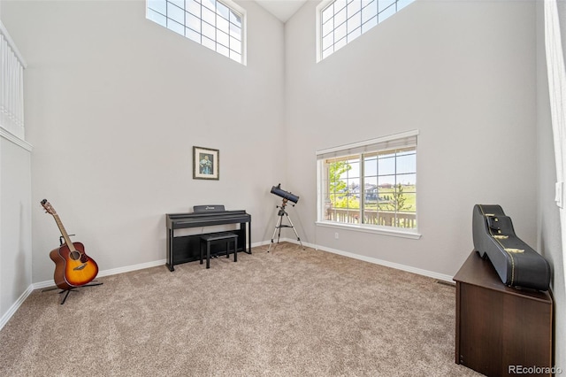 22227 E Hinsdale Ave, Aurora, CO 80016 - sitting room featuring a towering ceiling, healthy amount of natural light, carpet, and baseboards